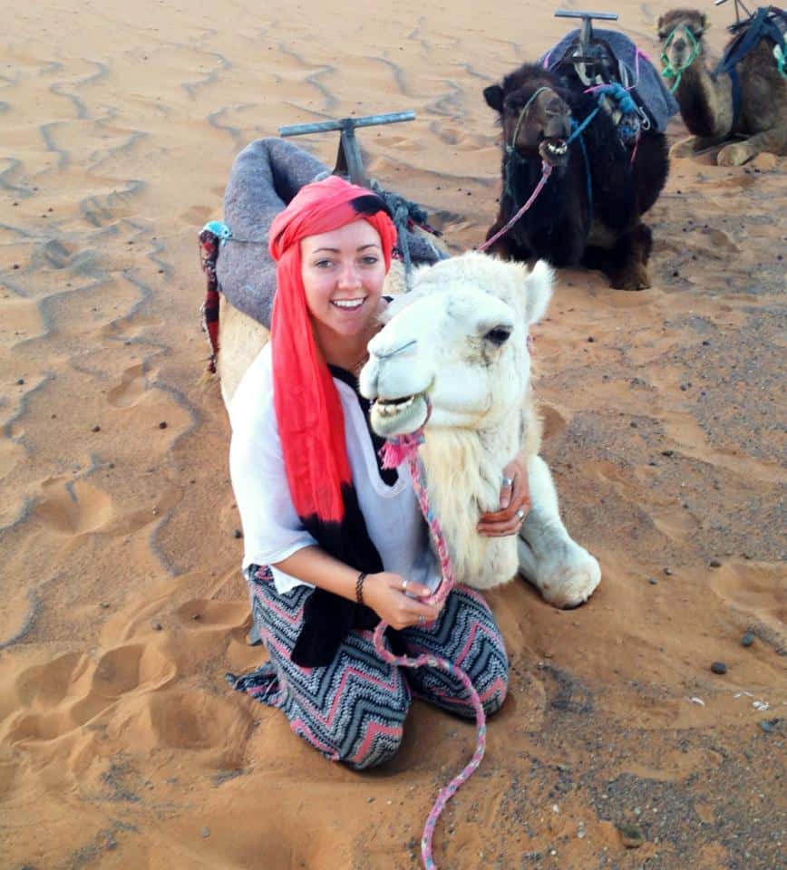 Jacqui posing with a camel in the Sahara Desert in Morocco.