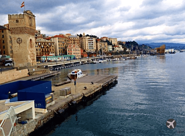 On top of a bridge overlooking water and buildings in Savona, Italy, where I was an au pair for three months. 