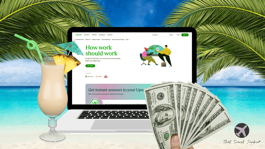 Laptop with Upwork on it, on the beach with cash and a pina colada